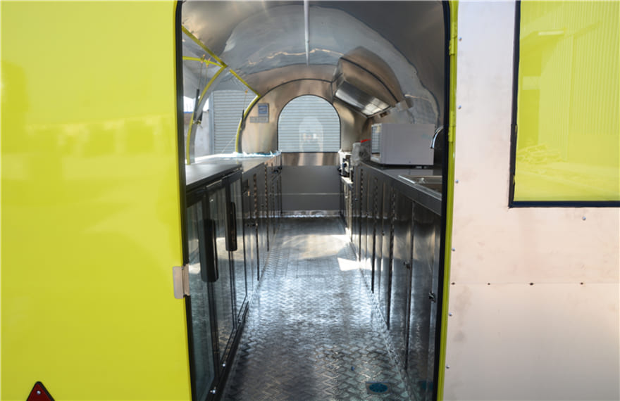 the inside of the yellow pizza concession trailer